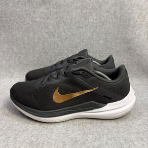Nike women’s grayish/Black Running Shoes with Gold Swoosh